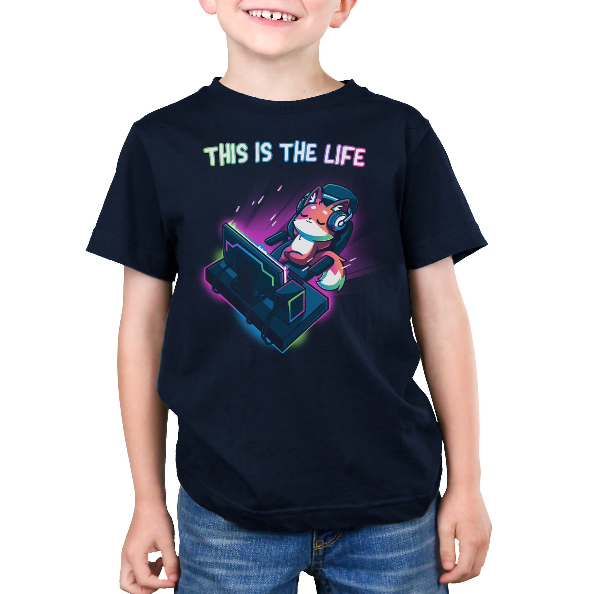 A child wearing a monsterdigital navy blue gaming t-shirt called "This Is the Life" with a graphic of a fox on a computer monitor and the text "This is the Life".