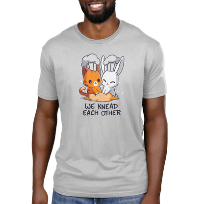 Premium Cotton T-shirt - A person wears a gray monsterdigital We Knead Each Other apparel, featuring a cartoon cat and rabbit in chef hats. The super soft ringspun cotton ensures comfort all day long.