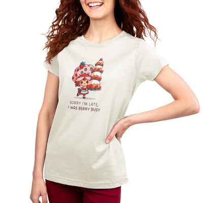 Premium Cotton T-shirt_TeeTurtle natural heather Sorry I Was Late, I Was Berry Busy apparel featuring Strawberry Shortcake holding a tall, large strawberry cake, and the caption, "Sorry I Was Late, I Was Berry Busy".