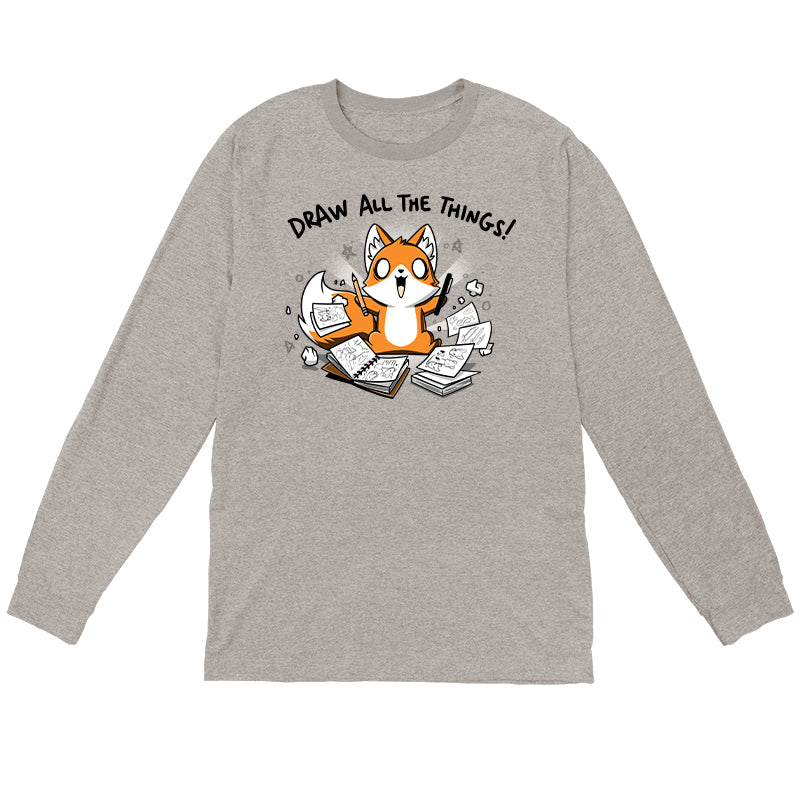 Long Sleeve T-shirt_A cartoon fox enthusiastically holding drawing tools, surrounded by sketchbooks with various drawings. Text above reads "Draw All The Things!" This monsterdigital original Draw all the Things! is crafted from super soft ringspun cotton for ultimate comfort.