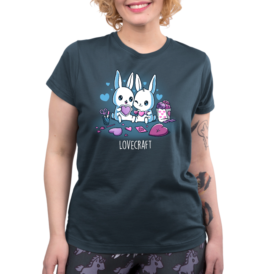 Premium Cotton T-shirt_TeeTurtle denim blue Lovecraft Bunnies Premium Cotton T-shirt featuring two bunnies doing love-themed crafts with hearts in the back and a caption that reads, "lovecraft".
