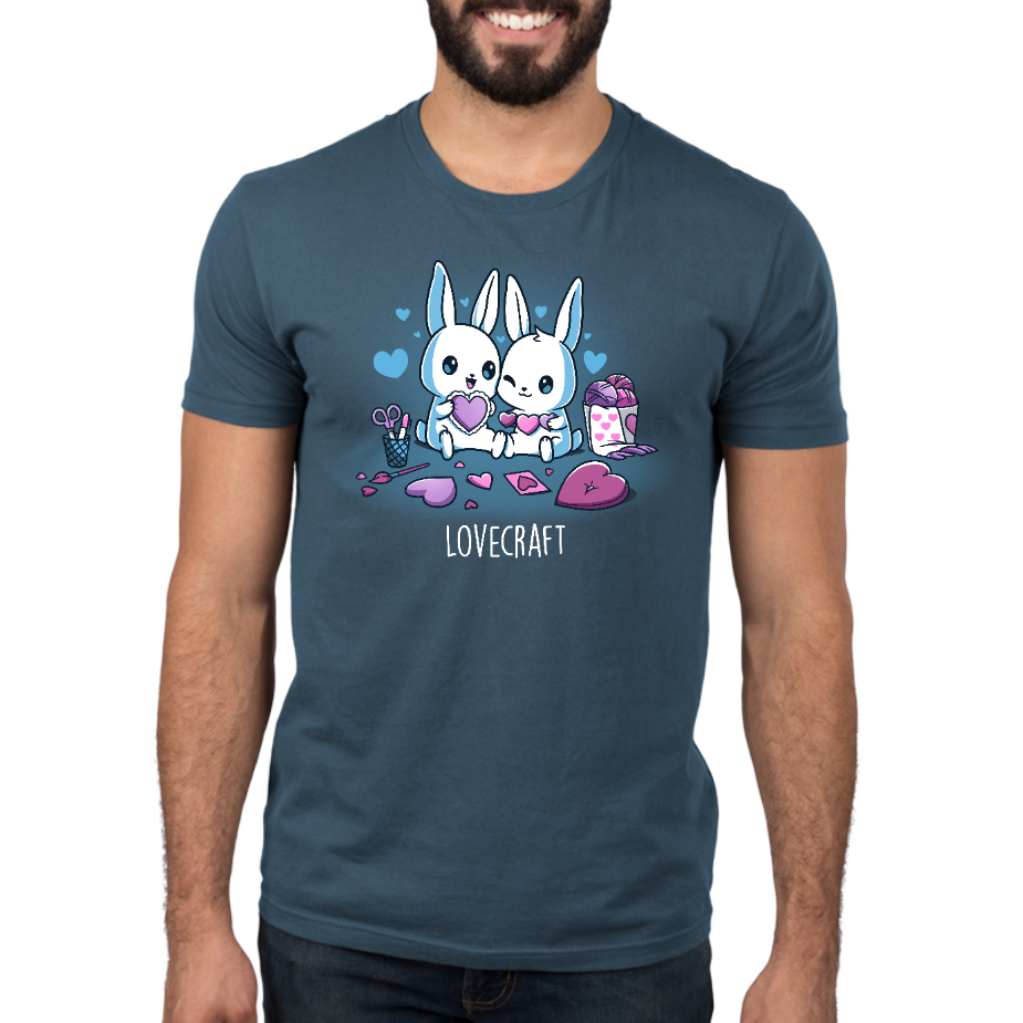 Premium Cotton T-shirt_TeeTurtle denim blue Lovecraft Bunnies Premium Cotton T-shirt featuring two bunnies doing love-themed crafts with hearts in the back and a caption that reads, "lovecraft".
