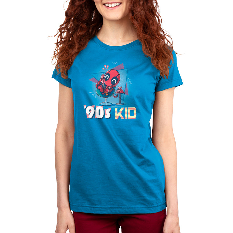 A woman wearing a blue t-shirt that says "Marvel '90s Kid" as an '90s kid.
