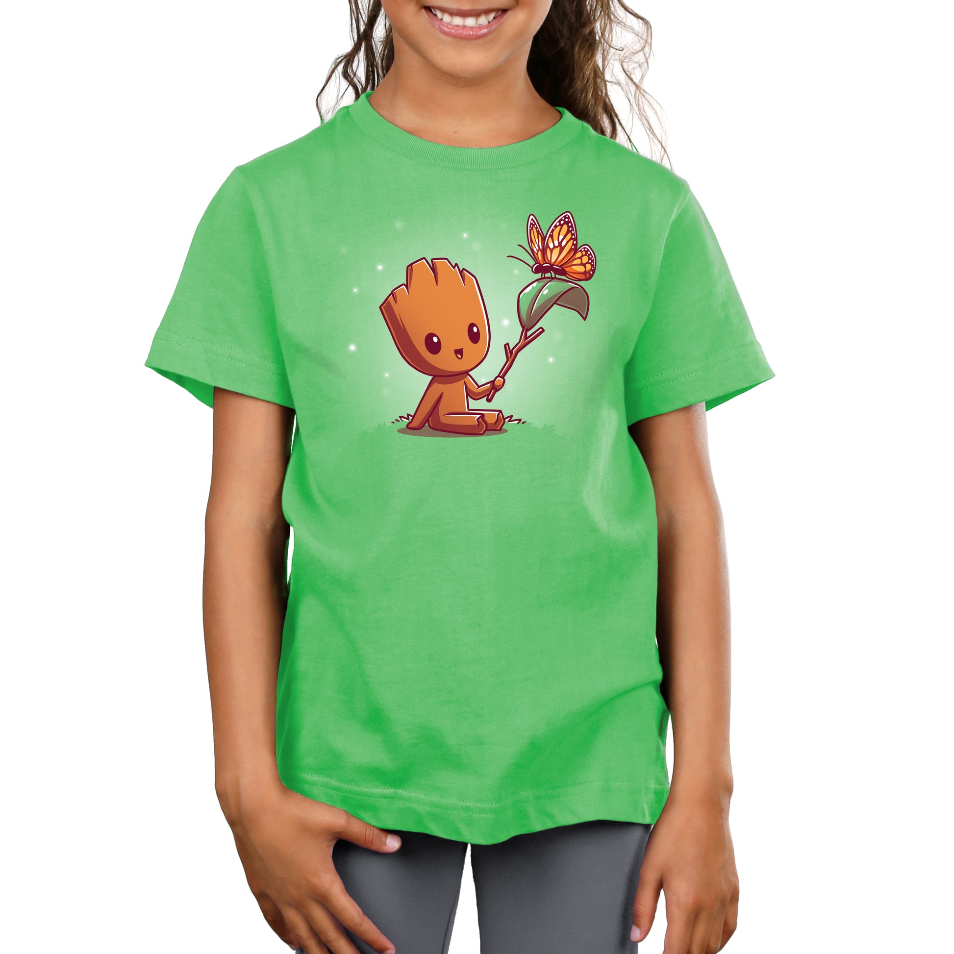 A girl wearing a green t-shirt with a licensed Marvel Lil' Groot design.