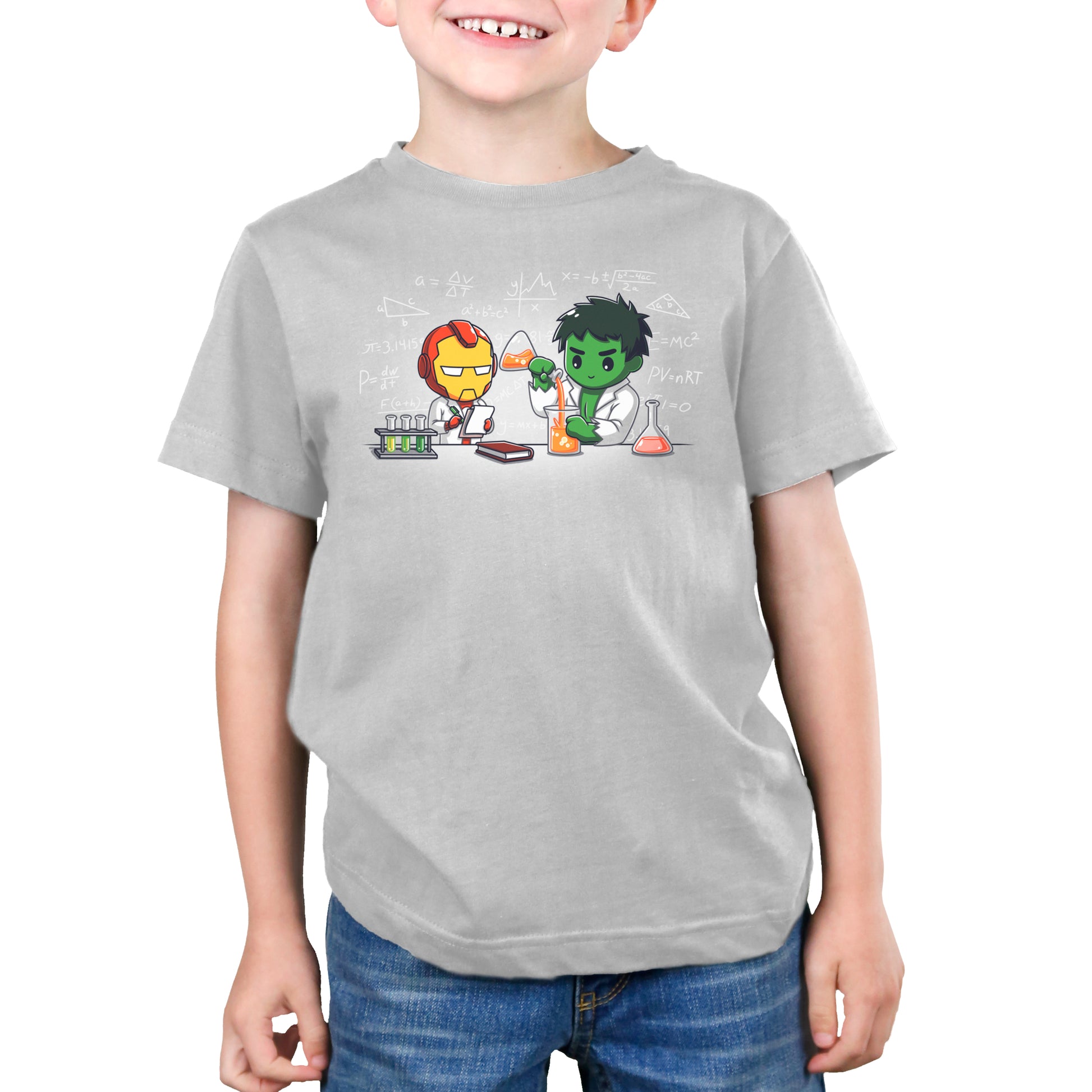 A young boy wearing a Marvel T-shirt with Iron Man and Hulk's Science Lab design.