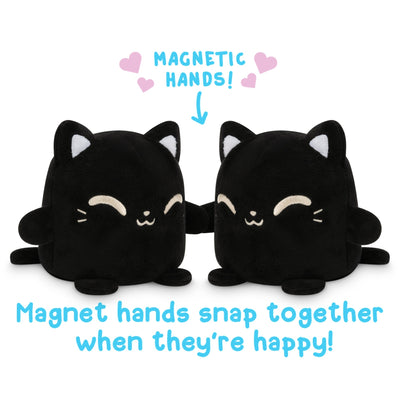 Two TeeTurtle Black Reversible Cat Plushmates, with magnetic hands that snap together when they're happy.