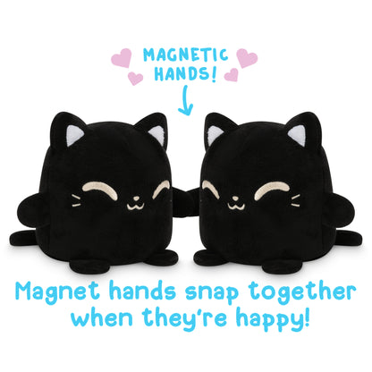 Two TeeTurtle Black Reversible Cat Plushmates, with magnetic hands that snap together when they're happy.