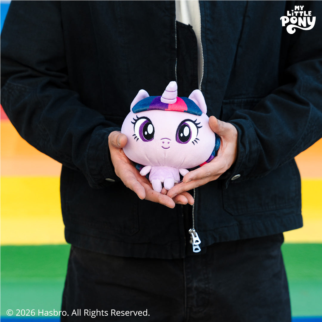 Cloudheads: 5" Twilight Sparkle held by a person in dark clothing against a rainbow stripe background