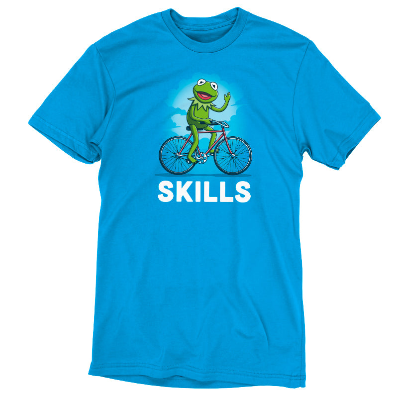 An officially licensed Disney Kermit T-shirt featuring a blue t-shirt with a frog riding a bicycle and the word "Skills".