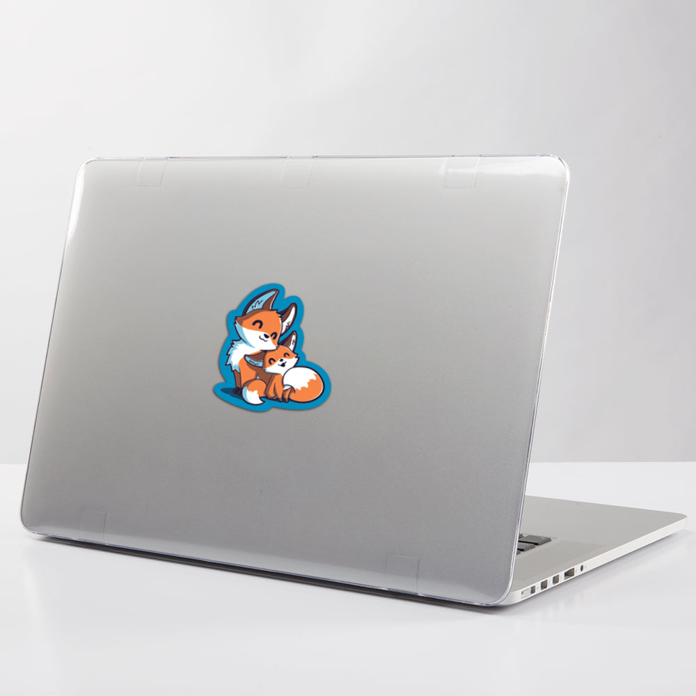 A water-resistant laptop with a Mama & Baby Fox Sticker by TeeTurtle on it.