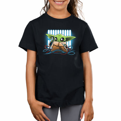 A girl wearing a Mechanic Grogu t-shirt from Star Wars.