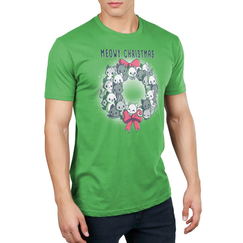 A man wearing a green t-shirt that says "Meowy Christmas Wreath" celebrates the holiday season. (Brand: TeeTurtle)