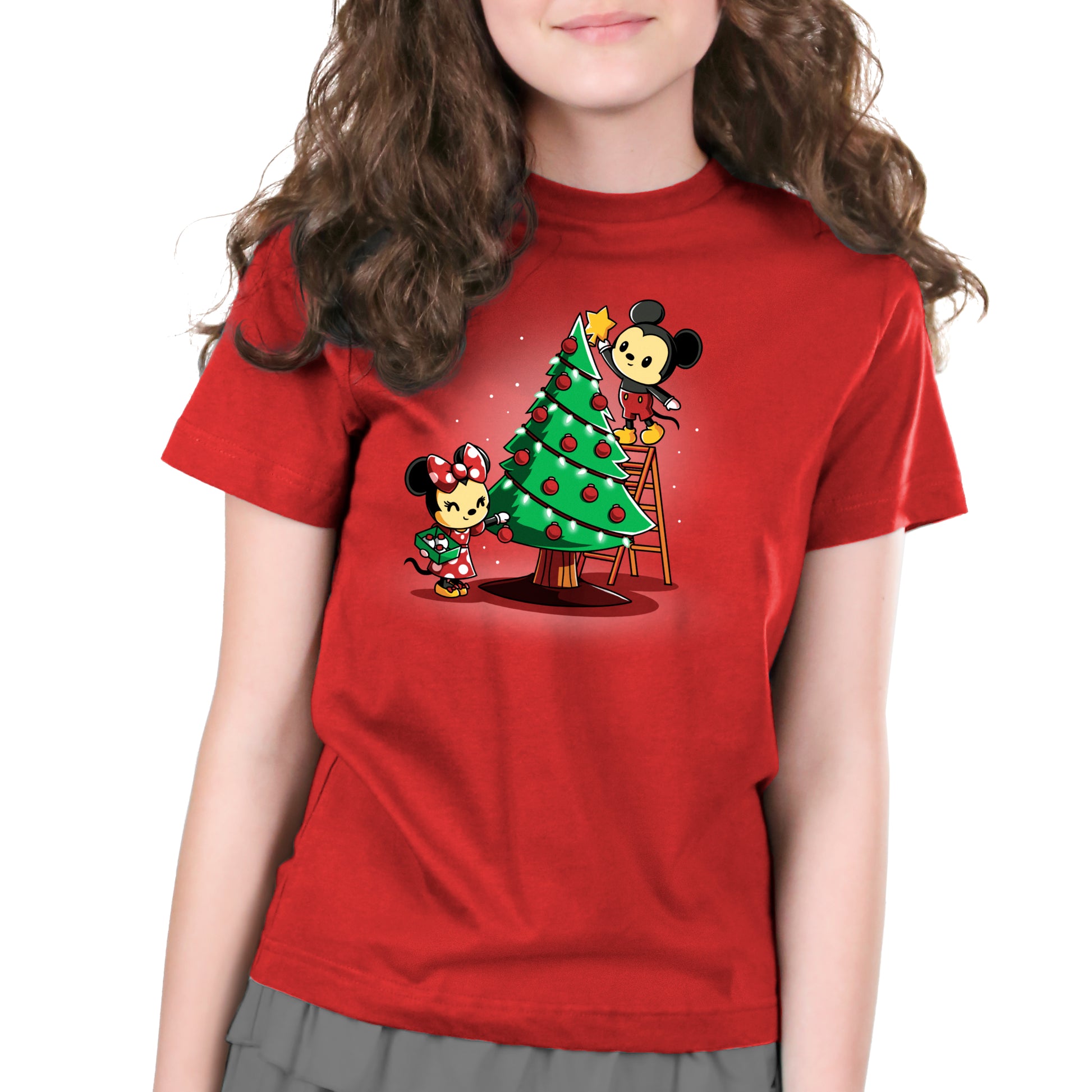 An officially licensed Disney Mickey and Minnie's Christmas Tree T-shirt featuring a girl wearing a red shirt with a Christmas tree.