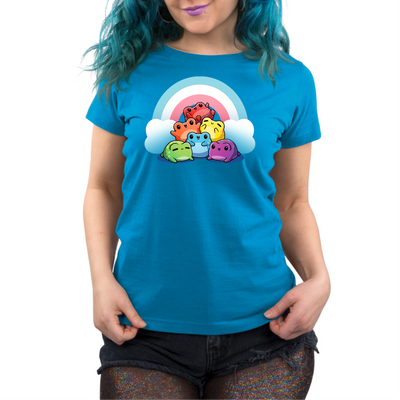 Premium Cotton T-shirt_TeeTurtle cobalt Hoppy Pride Premium Cotton T-shirt featuring a pyramid of happy frogs in the rainbow colors in front of a rainbow with the trans pride colors of light blue, white and pink. 