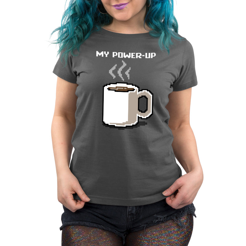 Premium Cotton T-shirt - A person with blue hair is wearing a charcoal gray monsterdigital My Power Up apparel made of Super Soft Ringspun Cotton, featuring an image of a steaming coffee mug and the text "MY POWER-UP." They are also wearing dark shorts, ready to embrace their morning coffee ritual.