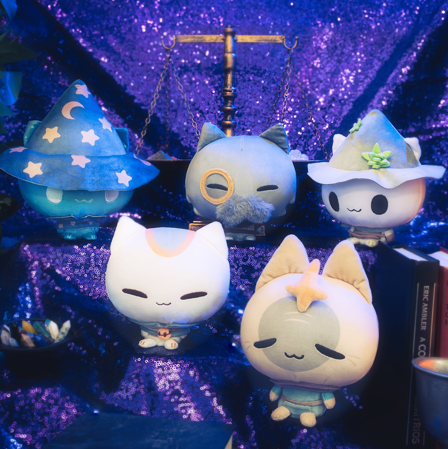 Mystic Moon Cloudheads Bundle - Bundle features all 10 cat witch character Cloudheads from our game Mystic Moon. This image shows some of the Cloudheads in front of a purple background with old books, a vintage scale and container of crystals visible. 