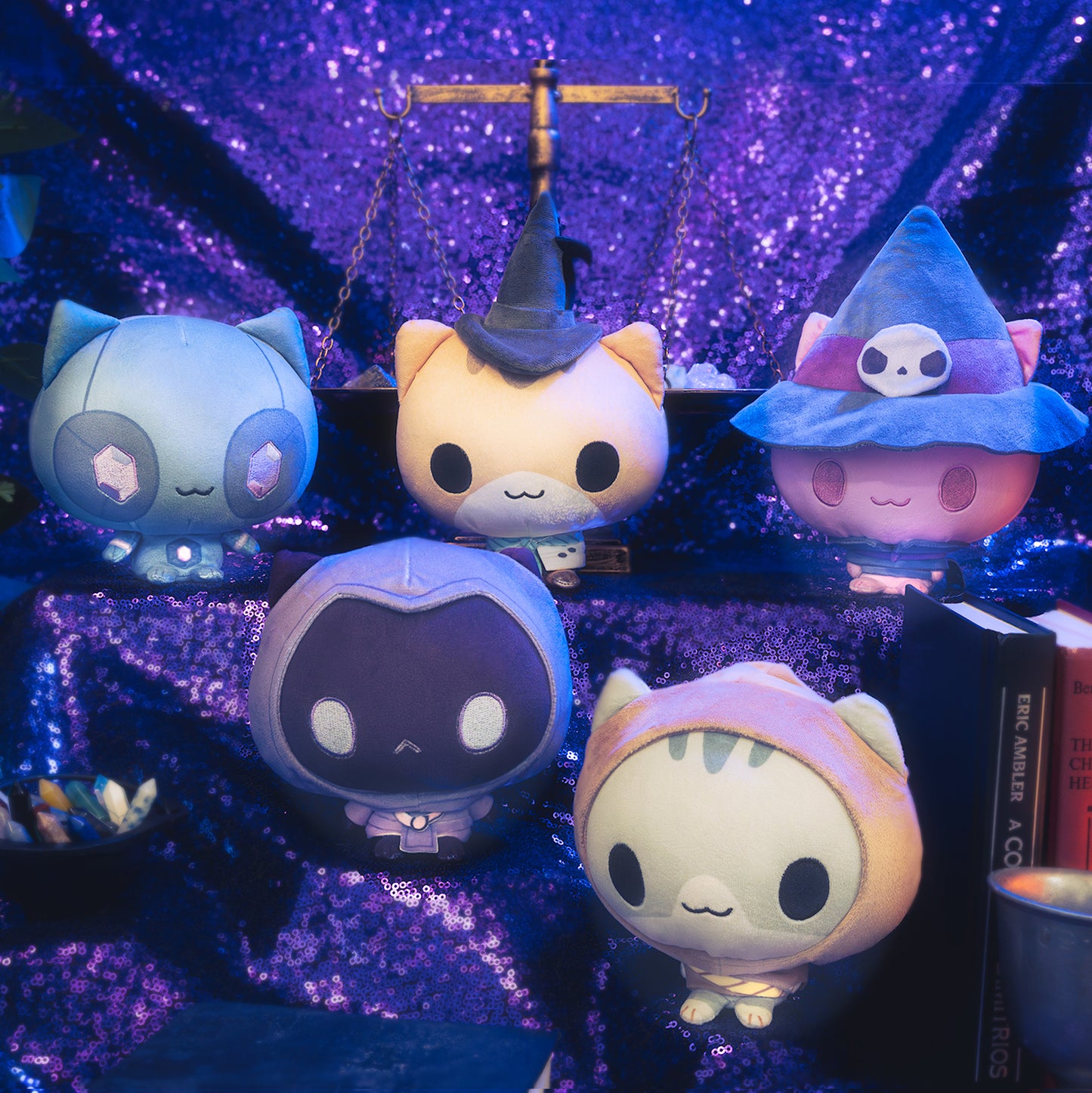 Mystic Moon Cloudheads Bundle - Bundle features all 10 cat witch character Cloudheads from our game Mystic Moon. This image shows some of the Cloudheads in front of a purple background with old books, a vintage scale and container of crystals visible. 