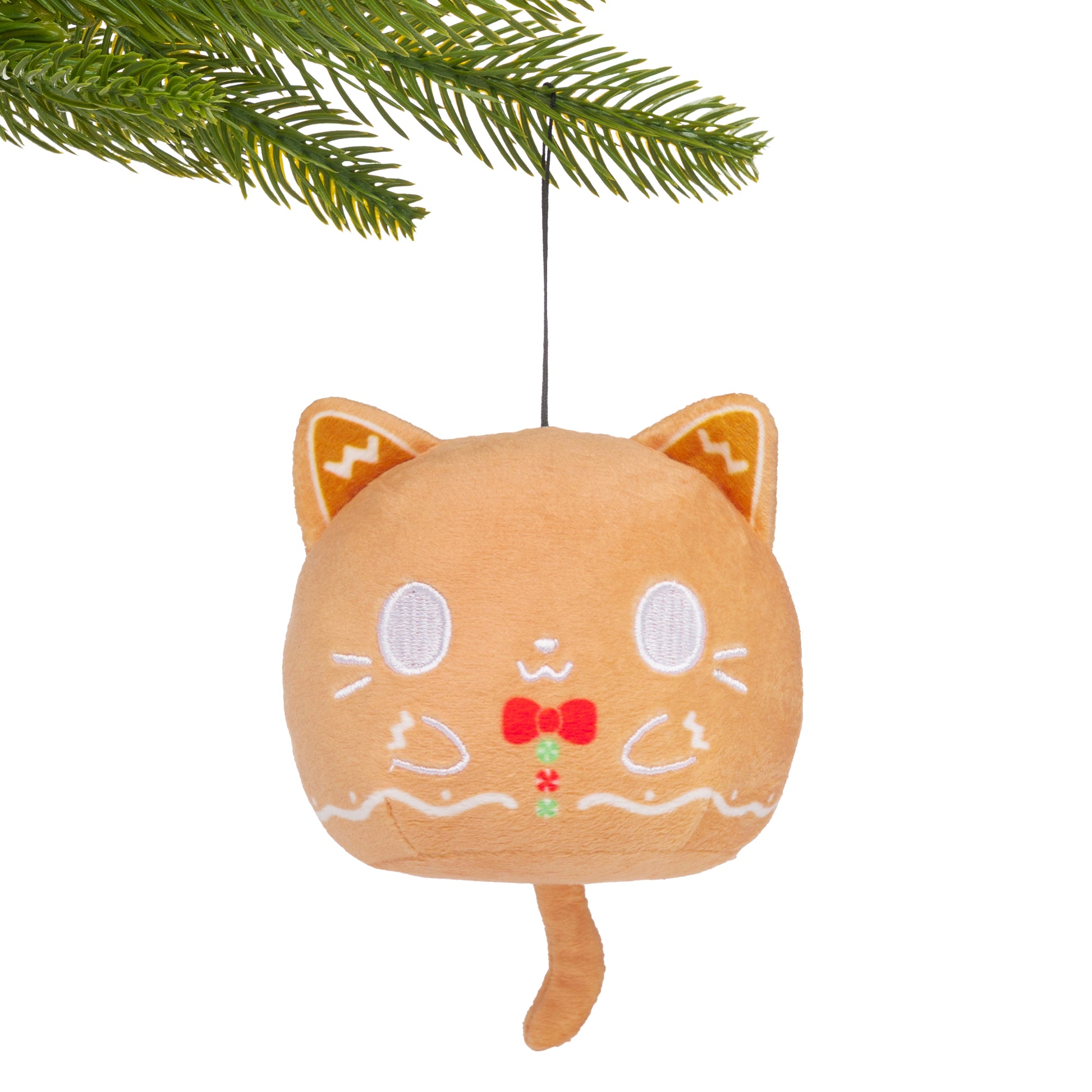 Gingerbread Cat Plushie Ornament hanging from a branch