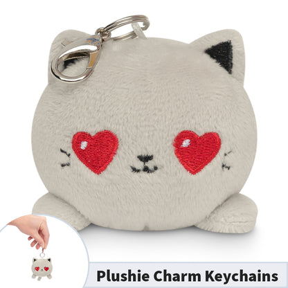 A TeeTurtle Cat Plushie Charm Keychain (Light Gray Love) is holding a key ring.