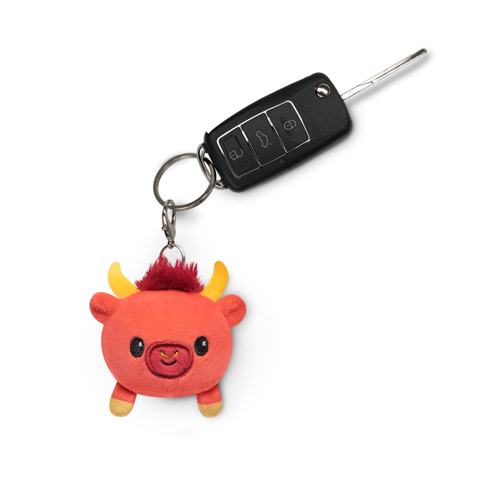 A TeeTurtle Lunar New Year Ox Plushie Charm Keychain with horns, perfect for your collection.