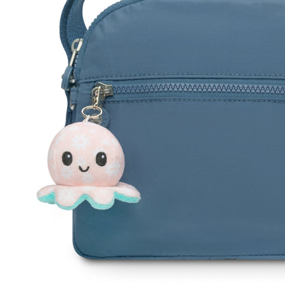 A blue purse with a TeeTurtle Octopus Plushie Charm Keychain.