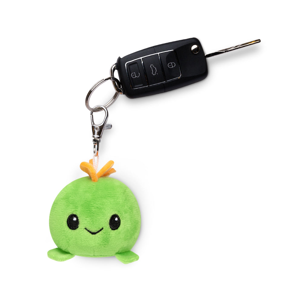 A portable TeeTurtle Stego Plushie Charm Keychain with a keychain attached to it.