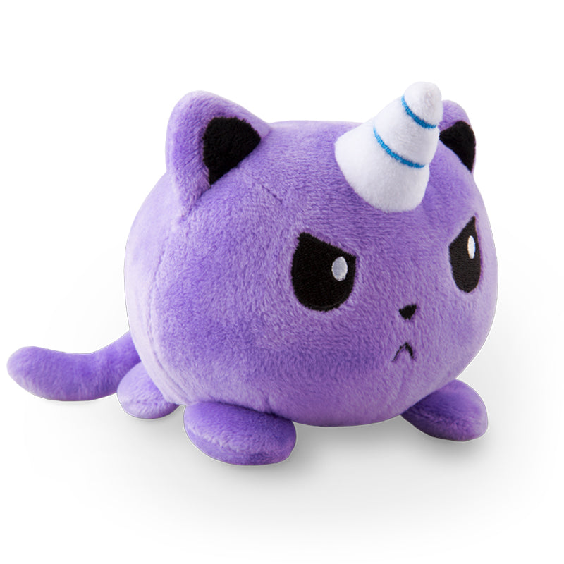 An angry Indigo TeeTurtle Kittencorn plushie with a soft unicorn hat on its head.