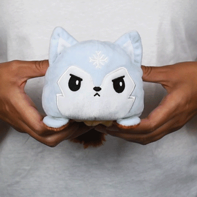 A TeeTurtle Reversible Wolf Plushie (Fall + Winter) from the brand TeeTurtle is being held in someone's hands.