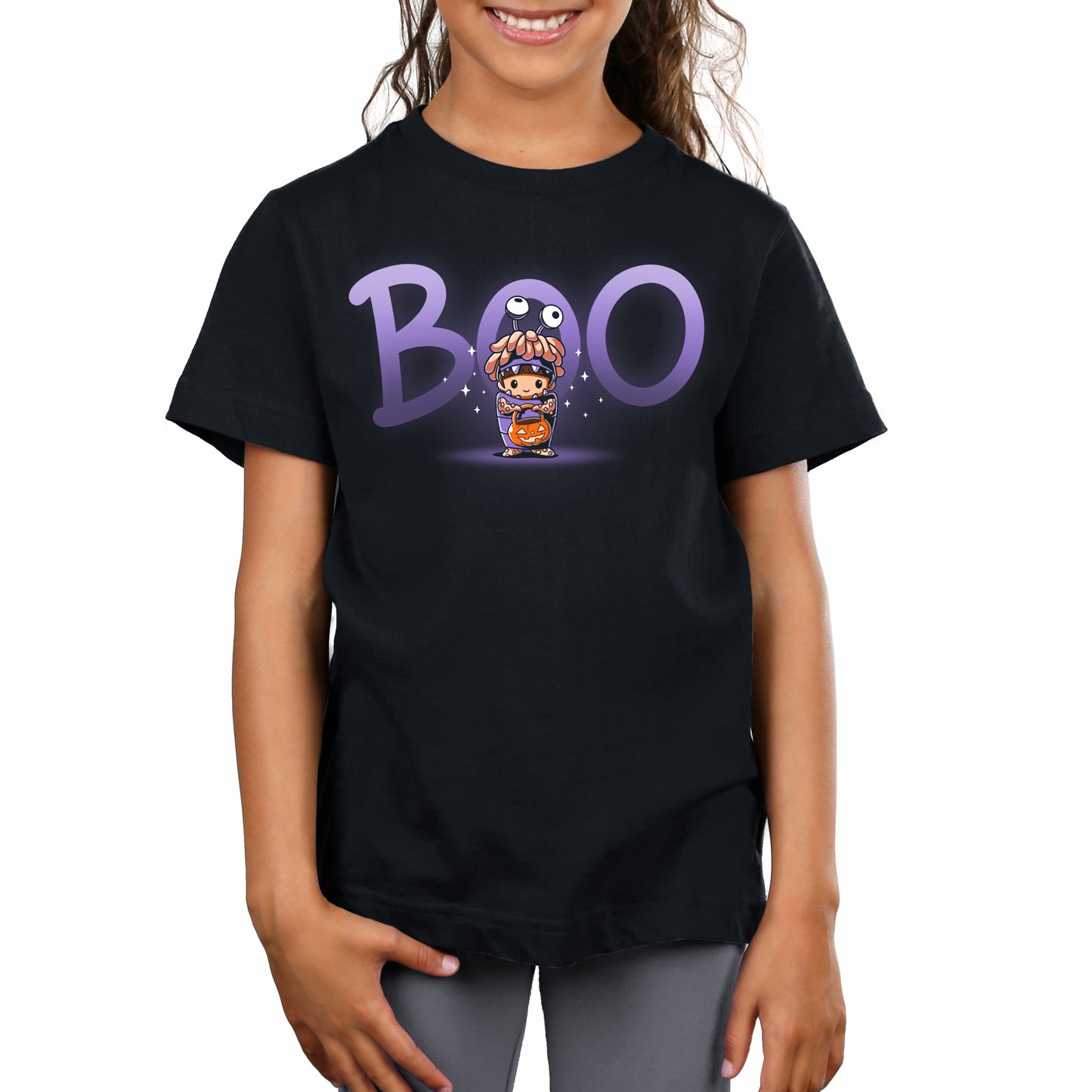 A girl wearing an officially licensed Pixar Monster's Inc black t-shirt with the word Boo's Halloween Costume on it.