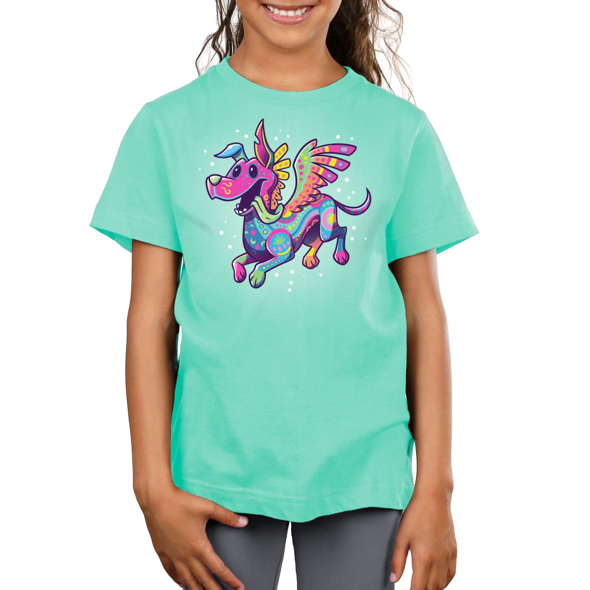 A girl wearing an officially licensed Pixar Dante the Alebrije turquoise T-shirt with a colorful dragon on it.