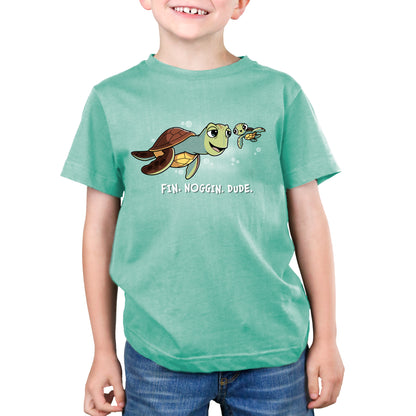 A young boy wearing an officially licensed Pixar Finding Nemo T-Shirt, called "Fin. Noggin. Dude.