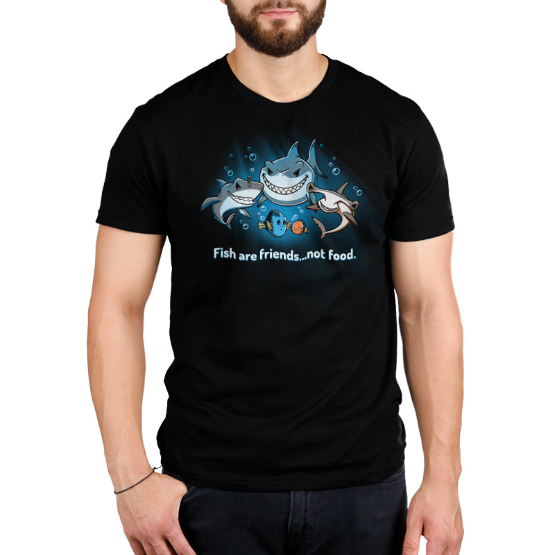A man wearing a Pixar officially licensed "Fish Are Friends...Not Food" black t-shirt with a shark on it.