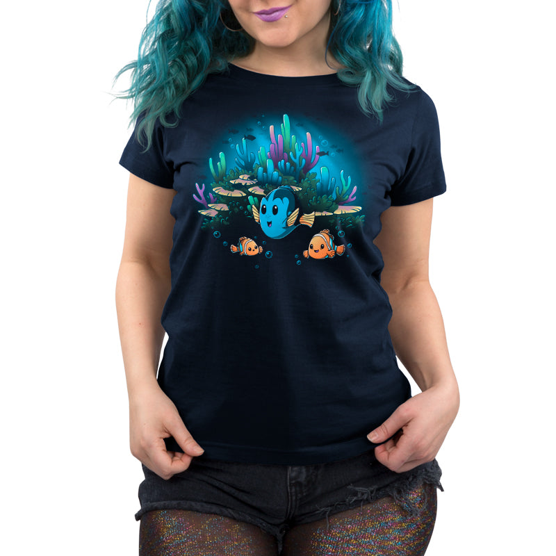A woman wearing a licensed, soft Pixar t-shirt with an image of Marlin, Nemo and Dory in an underwater scene.