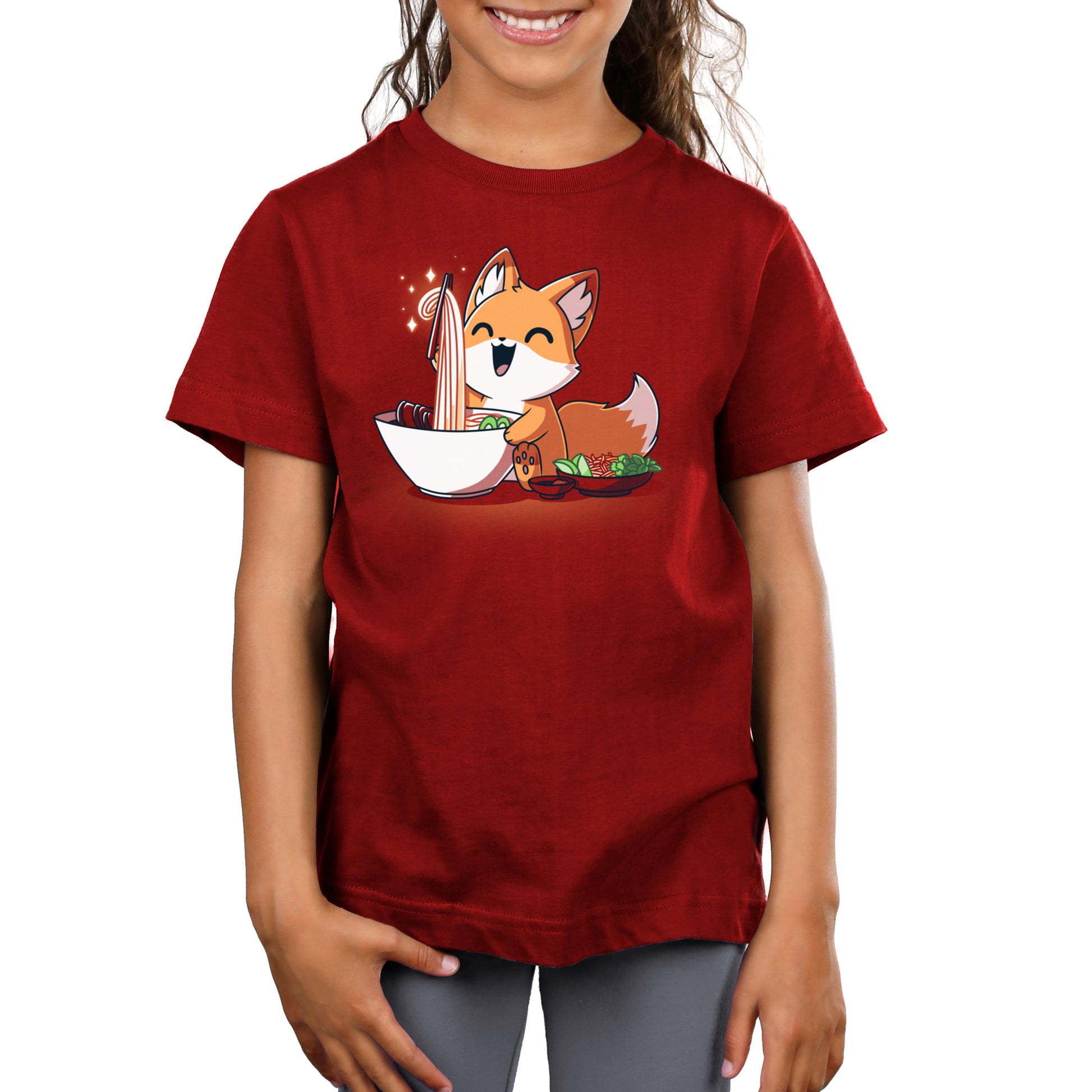 A girl wearing a red t-shirt with an image of Pho Fox in a bowl from TeeTurtle.