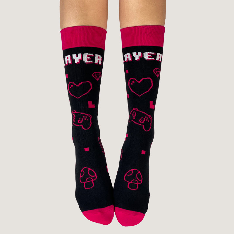 A woman wearing a pair of TeeTurtle Player 1 Socks, worn with pride.