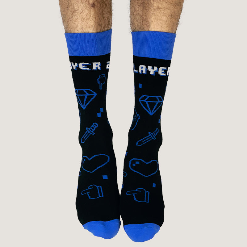 A man wearing a comfortable black and blue Player 2 sock with a heart on it.