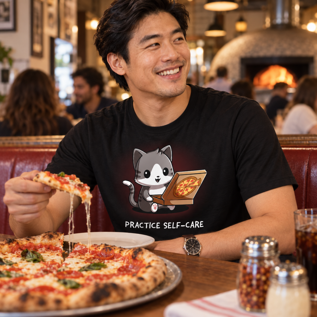 Men's Premium T-Shirt_TeeTurtle black Practice Self-Care Men's Premium T-Shirt featuring a happy gray-and-white cat holding an open pizza box with a pepperoni pizza and the text "Practice Self-Care."