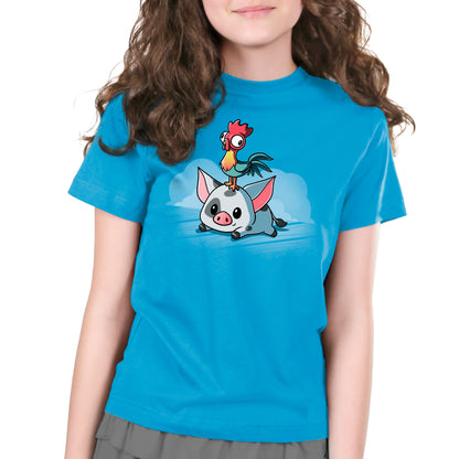 A girl wearing a blue t-shirt with the Disney's Moana characters Pua and Hei Hei on it.