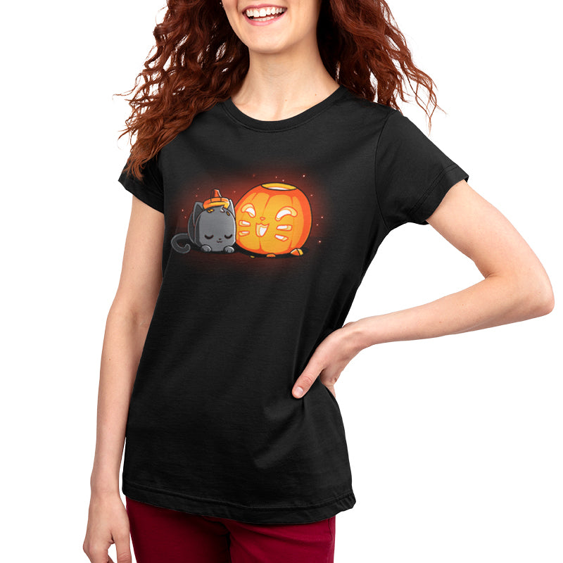 A woman wearing a festive black Pumpkin Carver t-shirt with a cat and pumpkin on it from TeeTurtle.