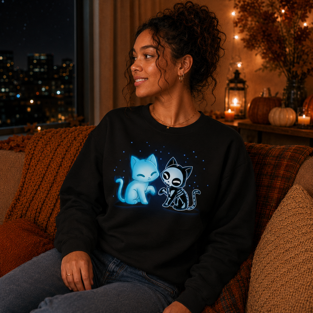 Crew Neck Sweatshirt_TeeTurtle black Purranormal Pals Crew Neck Sweatshirt featuring a glowing blue ghost cat sitting beside a smiling skeleton cat, surrounded by small blue stars.