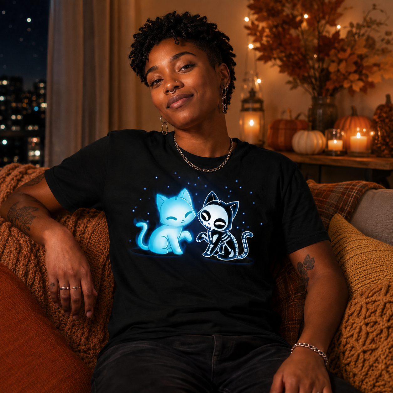 Men's Premium T-shirt_TeeTurtle black Purranormal Pals Men's Premium T-Shirt featuring a glowing blue ghost cat sitting beside a smiling skeleton cat, surrounded by small blue stars.