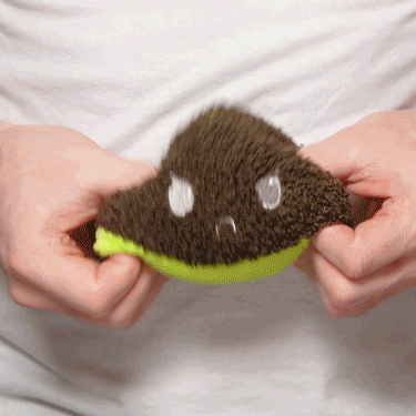 A person holding a TeeTurtle Reversible Avocado Plushie.