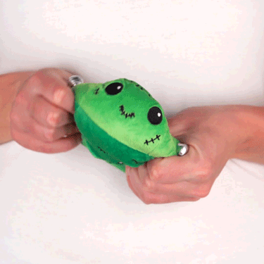 A person holding a TeeTurtle Reversible Monster Plushie.