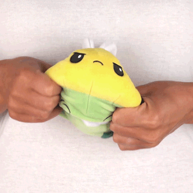 A person holding a TeeTurtle Reversible Boo Bee Plushie.
