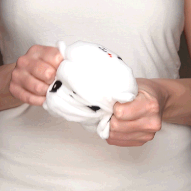 A woman holding a TeeTurtle Reversible Killer Bunny Plushie.