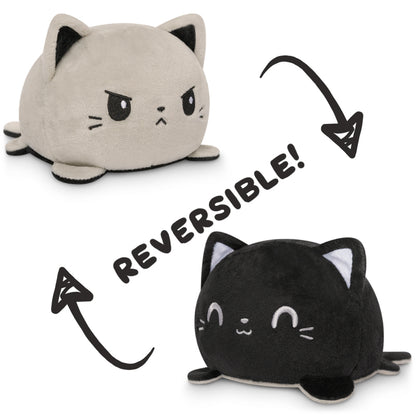 TeeTurtle's TeeTurtle Reversible Cat Plushie (Gray + Black) is a must-have for all fans of mood plushies. This adorable toy allows you to flip it inside out, revealing a different expression and mood each.