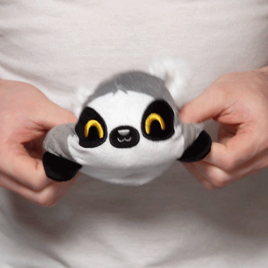 A person is holding a TeeTurtle Reversible Lemur Plushie.