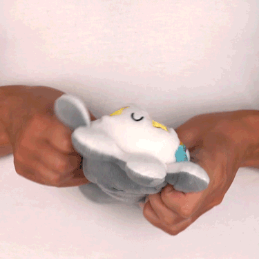 A person is holding a TeeTurtle Reversible Octopus Plushie (Gray + White Sparkle) in their hands.