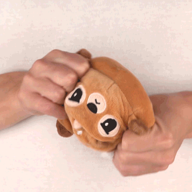 A person is holding a TeeTurtle Reversible Reindeer Plushie (Red Nose).