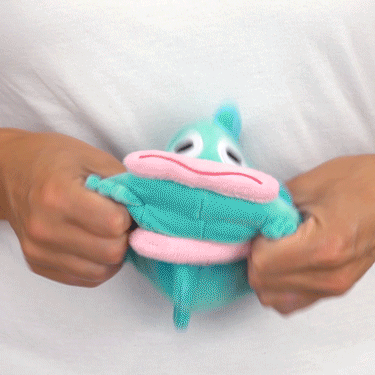 A person holding a blue and pink Sanrio TeeTurtle Reversible Hangyodon plushie, also known as a mood plushie.